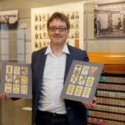 Präsident Daniel Grütter mit Spielkartenentwürfen in der Spielkartensammlung des Museums